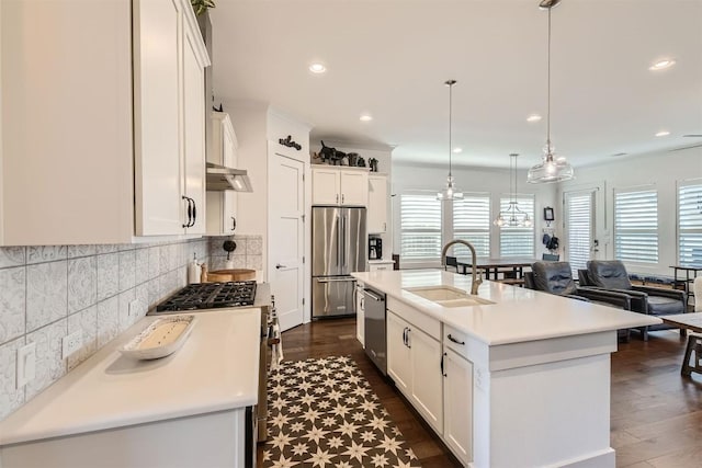 1100 Railroad Ave, Georgetown, TX 78626 - kitchen with high quality appliances, a sink, light countertops, white cabinets, and under cabinet range hood