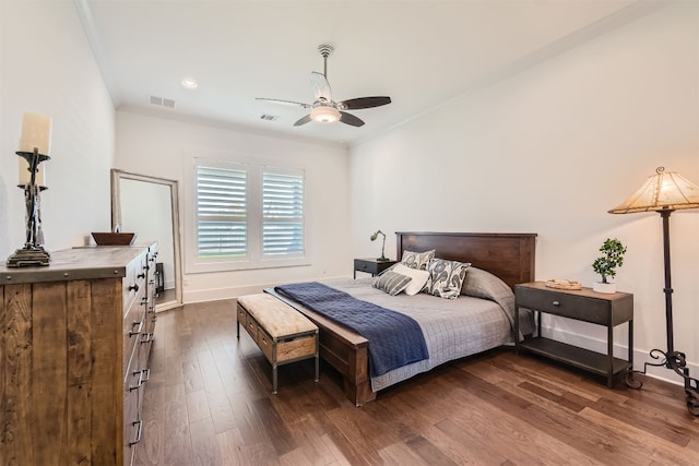 bedroom with dark hardwood / wood-style floors and ceiling fan