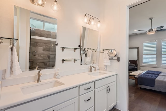 bathroom featuring vanity, an enclosed shower, wood-type flooring, and ceiling fan