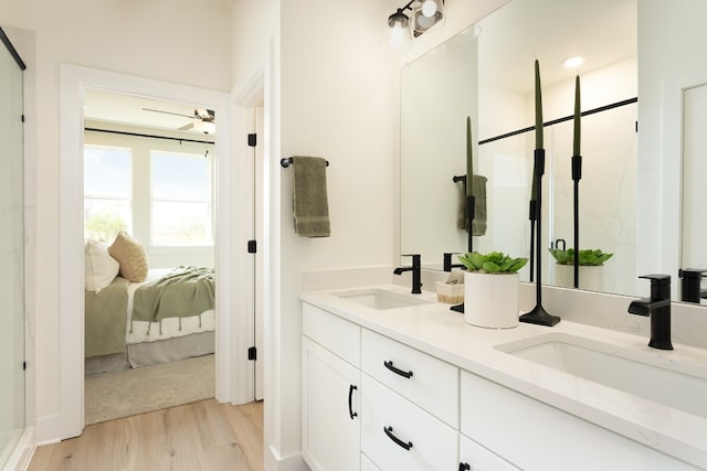 bathroom with vanity, hardwood / wood-style floors, ceiling fan, and walk in shower