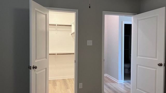 hallway with light hardwood / wood-style flooring