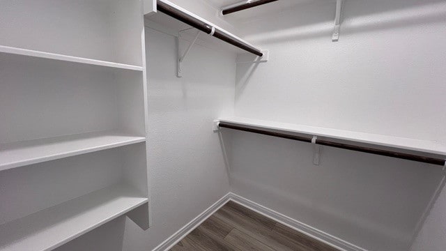 walk in closet featuring dark hardwood / wood-style floors