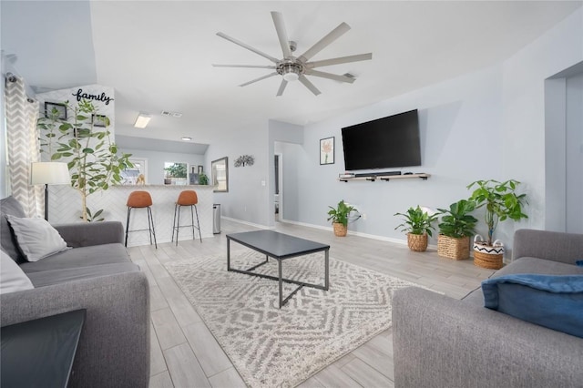 living room featuring ceiling fan and light hardwood / wood-style floors