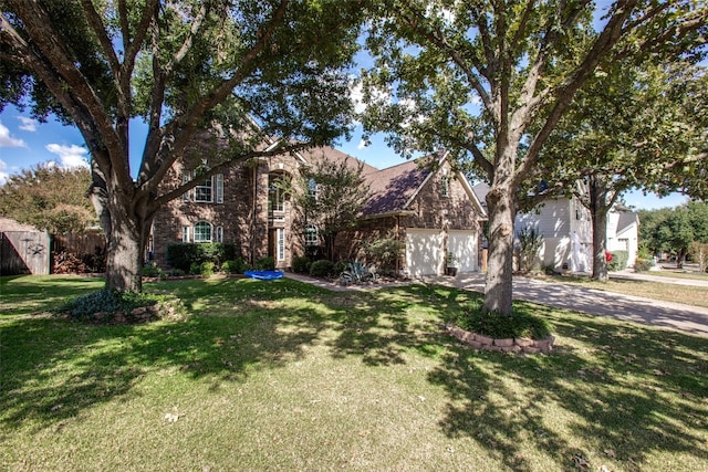 view of front of home featuring a front yard and a garage