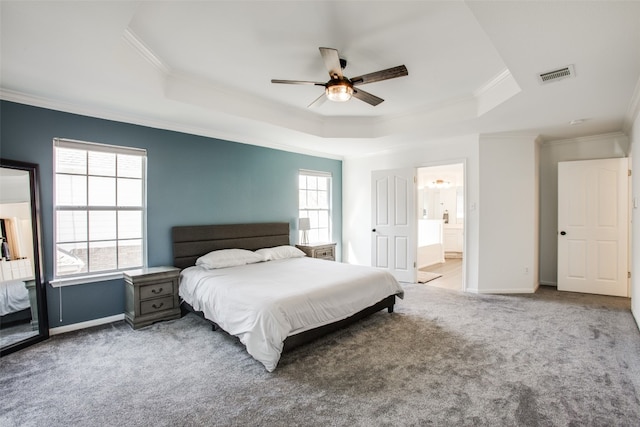 carpeted bedroom with ceiling fan, a raised ceiling, multiple windows, and crown molding