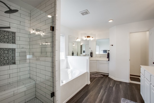 bathroom featuring vanity, independent shower and bath, and wood-type flooring