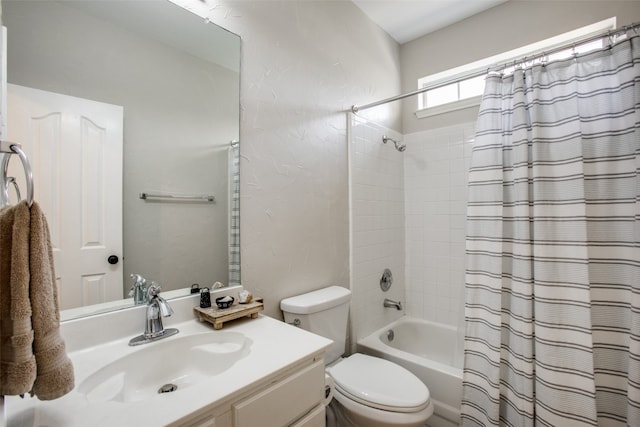 full bathroom with vanity, shower / bath combination with curtain, and toilet