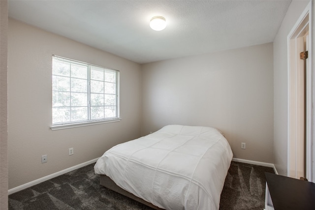 bedroom with dark carpet