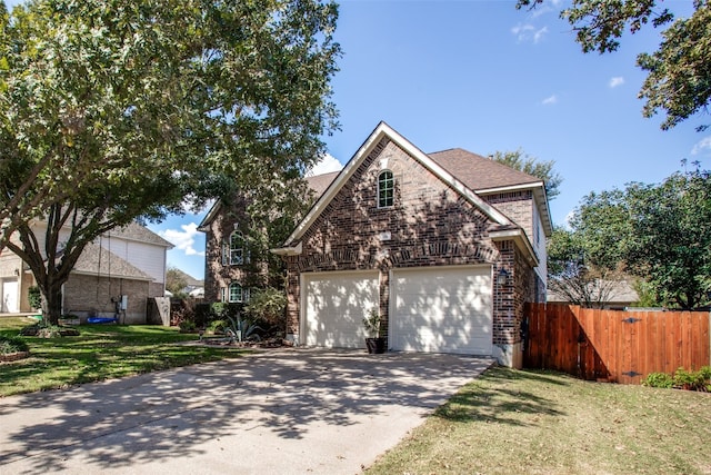 front of property with a garage and a front lawn