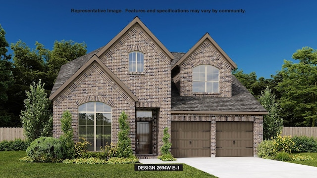 view of front of property featuring a front lawn and a garage