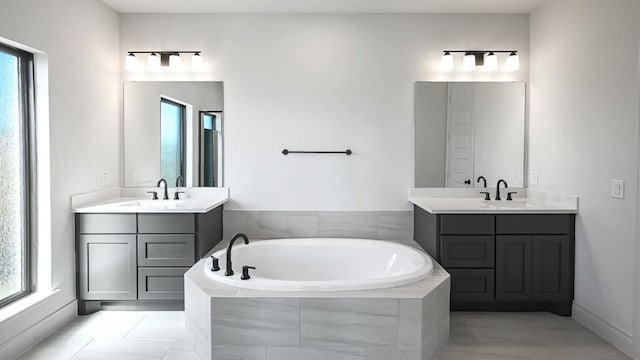 bathroom with vanity and tiled bath