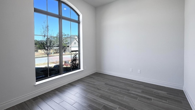 spare room featuring dark hardwood / wood-style flooring