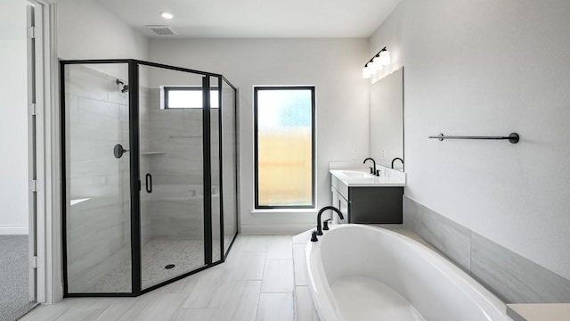 120 Teakmill Trl, San Marcos, TX 78666 - bathroom featuring a stall shower, a garden tub, healthy amount of natural light, and vanity