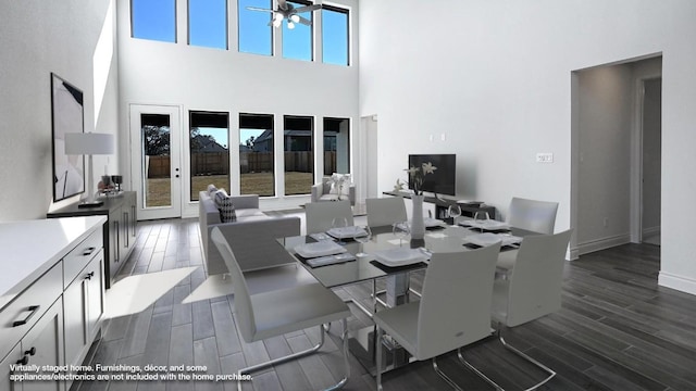 dining area featuring a towering ceiling and ceiling fan