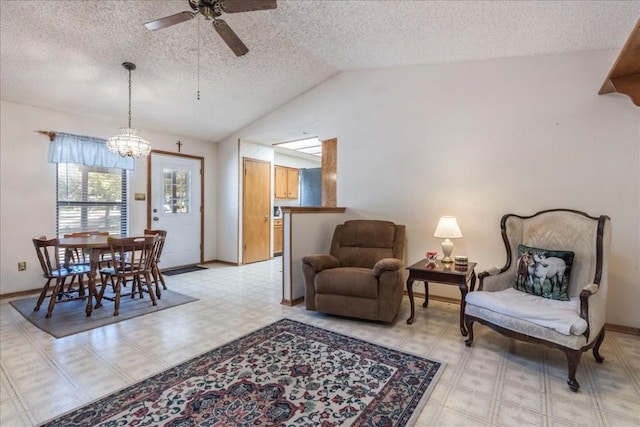 living room featuring a textured ceiling, lofted ceiling, light floors, and ceiling fan with notable chandelier