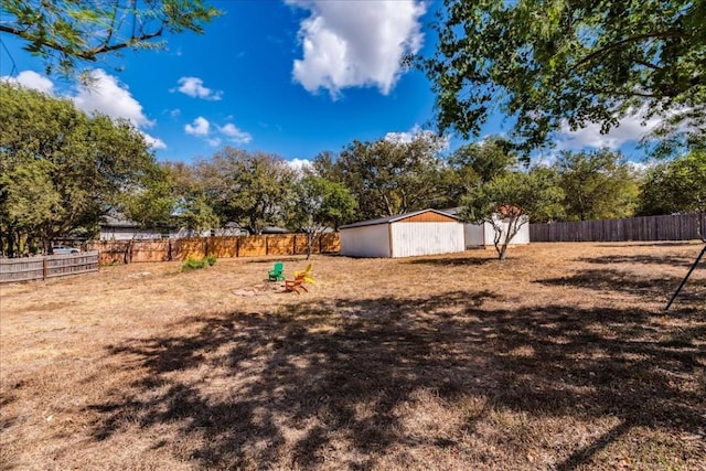 view of yard with an outdoor structure and fence