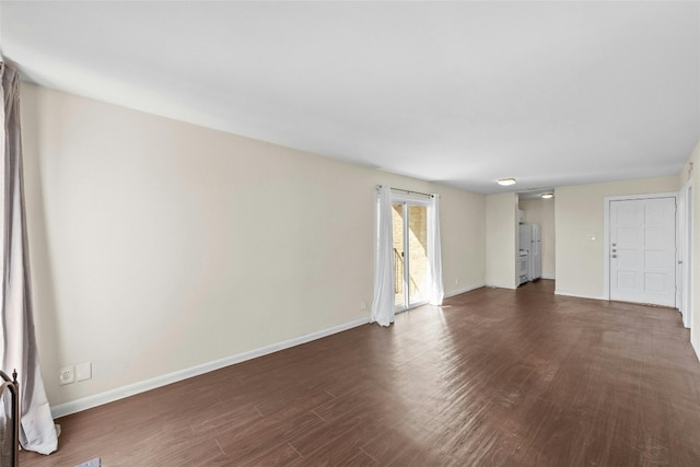 spare room with dark hardwood / wood-style floors