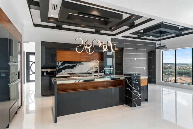 kitchen featuring oven, backsplash, a raised ceiling, and pendant lighting