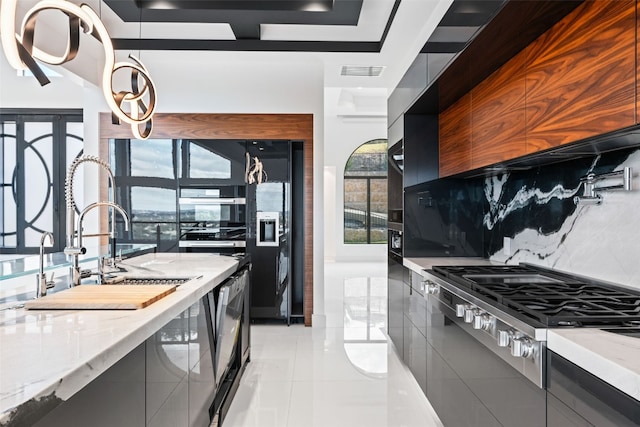 kitchen with stainless steel gas cooktop, decorative backsplash, light stone counters, and light tile patterned floors