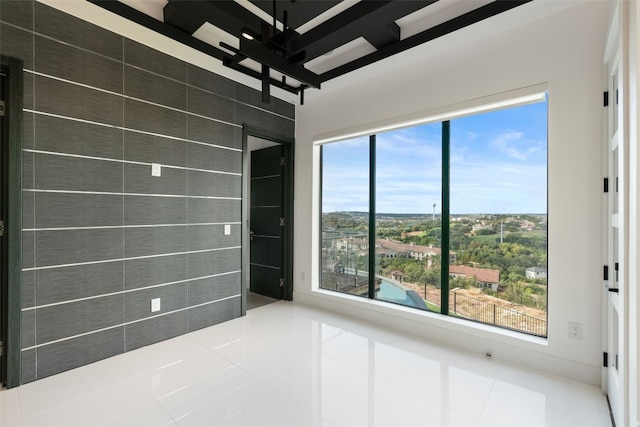 tiled empty room with a wealth of natural light