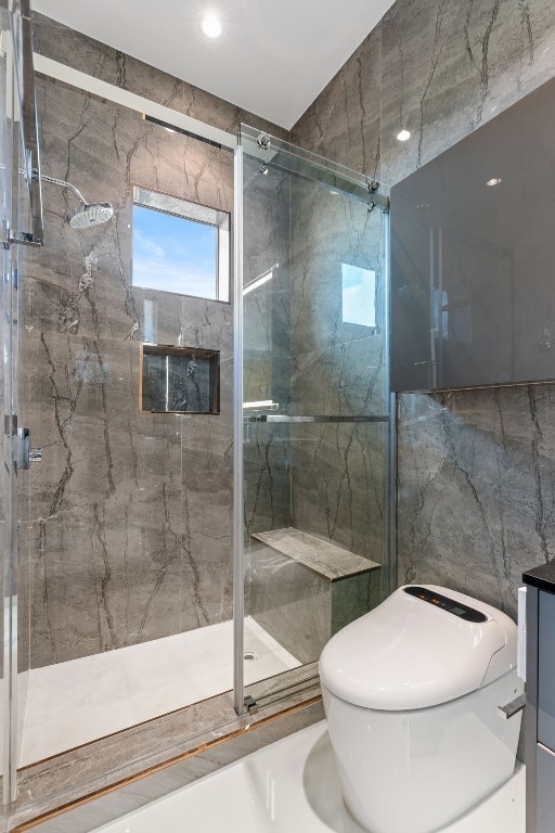 bathroom featuring vanity, tile walls, and a shower with door