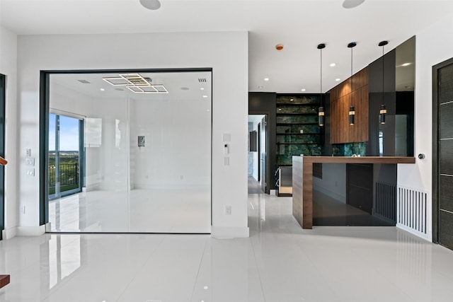 kitchen featuring light tile patterned flooring and decorative light fixtures