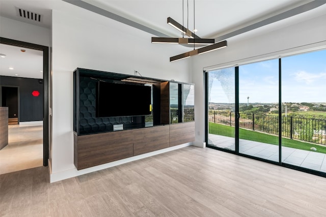 unfurnished living room with ceiling fan and wood-type flooring