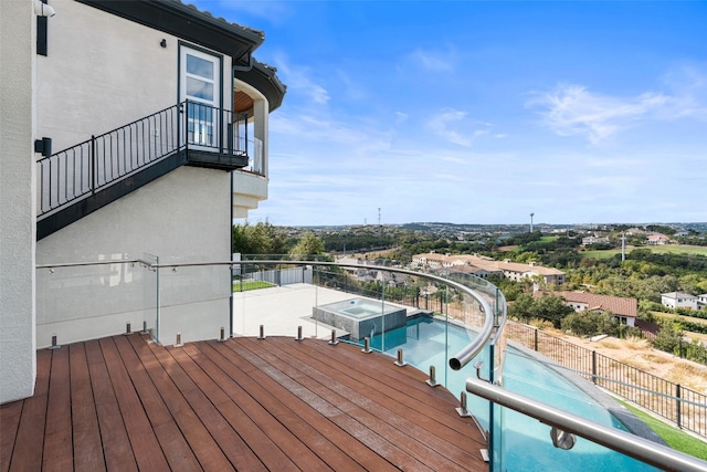 wooden terrace featuring a fenced in pool