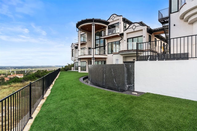 view of yard with a balcony