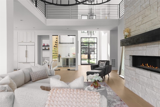 living room featuring a fireplace, concrete flooring, and a high ceiling