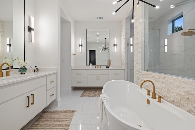 bathroom featuring shower with separate bathtub, vanity, and a notable chandelier