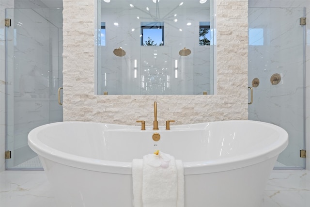 bathroom with tile walls and independent shower and bath