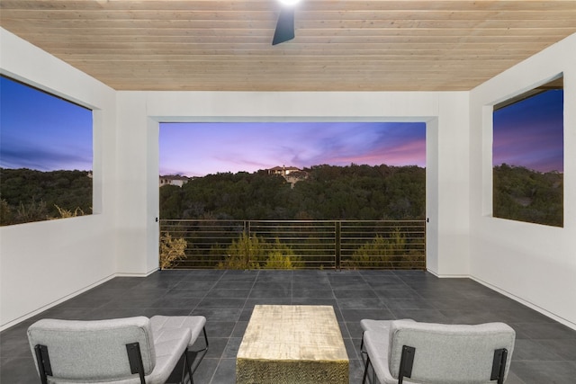 interior space with ceiling fan and wood ceiling