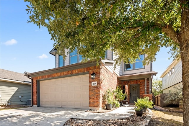 view of front of property featuring cooling unit and a garage