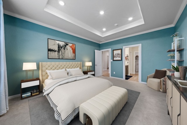 carpeted bedroom with ornamental molding and a tray ceiling