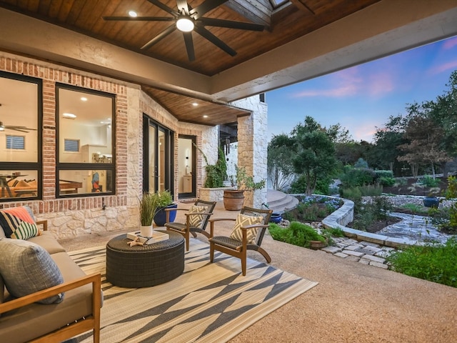 patio terrace at dusk featuring outdoor lounge area and ceiling fan