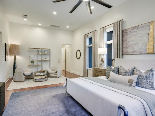 bedroom with wood-type flooring and ceiling fan