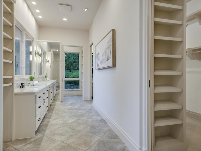 bathroom featuring vanity, tile patterned floors, and built in shelves