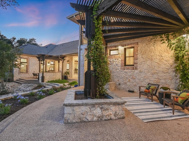 patio terrace at dusk with a pergola