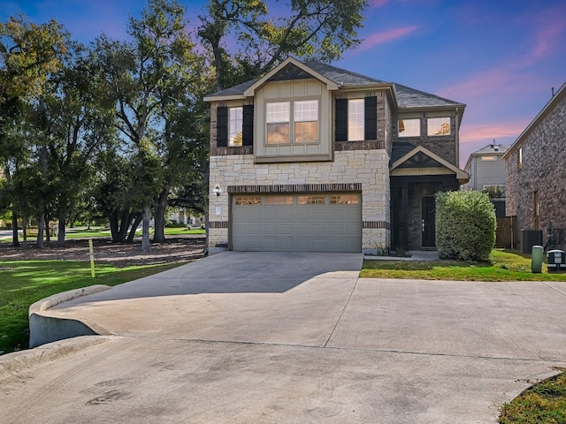 view of front of house featuring central AC and a garage