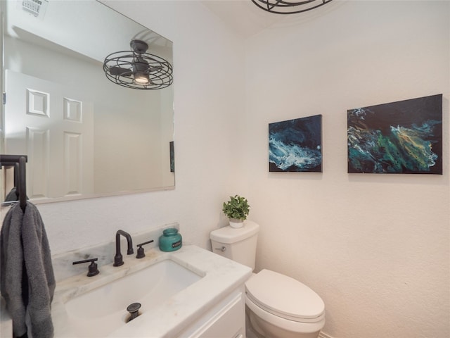 bathroom with ceiling fan, toilet, and vanity