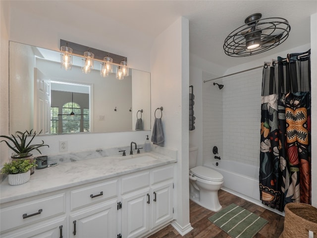 full bathroom with vanity, ceiling fan, toilet, wood-type flooring, and shower / tub combo