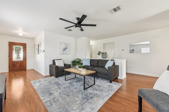 living room with ceiling fan and light wood-type flooring