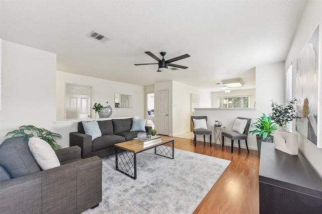 living room featuring ceiling fan and wood-type flooring