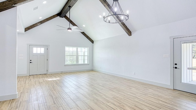 entryway with ceiling fan with notable chandelier, a healthy amount of sunlight, beam ceiling, and high vaulted ceiling