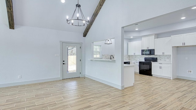 foyer entrance featuring lofted ceiling with beams, a notable chandelier, and sink