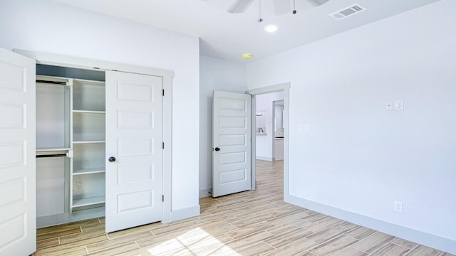 unfurnished bedroom featuring ceiling fan and a closet