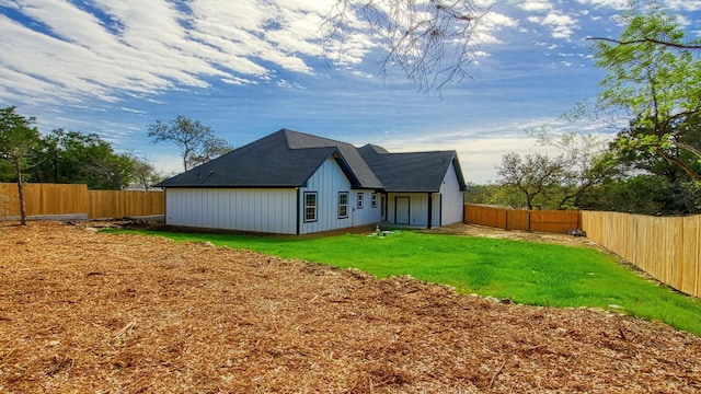 rear view of house with a yard