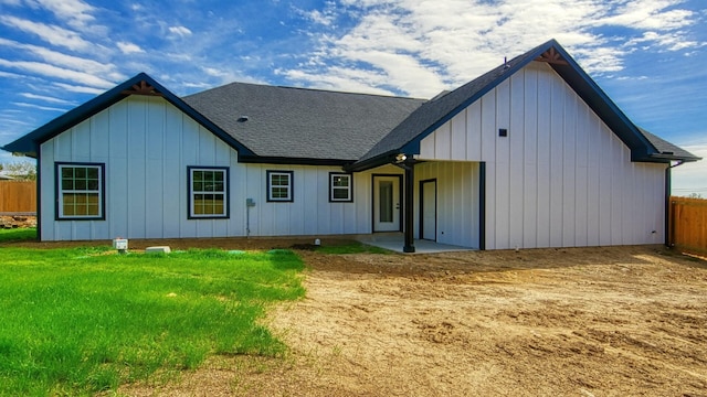 rear view of house with a lawn and a patio area