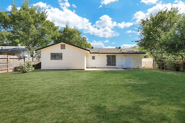 back of property featuring a yard and a patio area